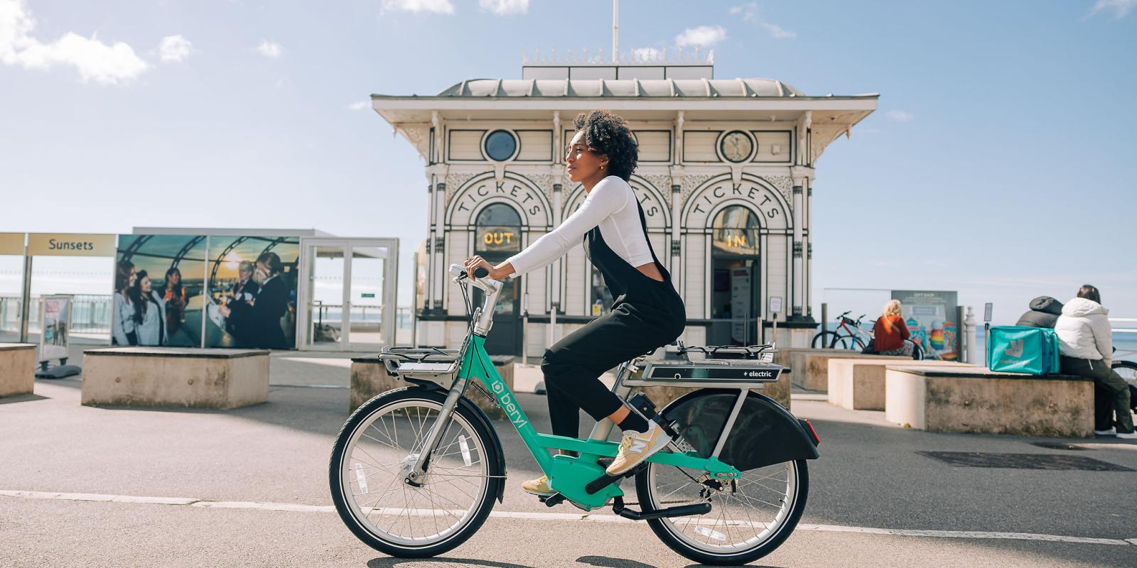woman riding Beryl BTN e-bike on Brighton seafront