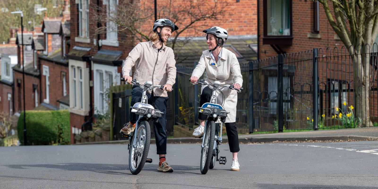 Cllr Helen Hayden and Phil Ellis riding the Leeds City Bikes in new area 